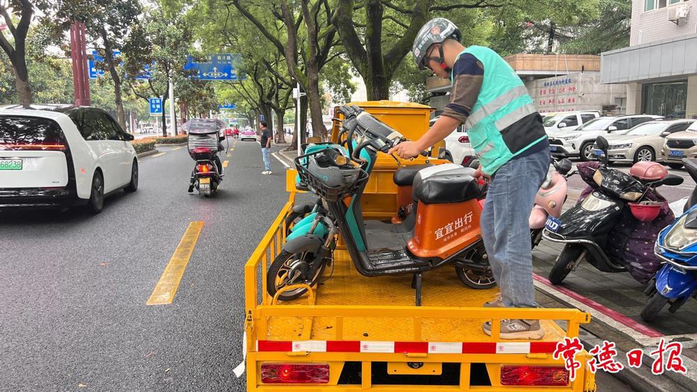 工作人员对共享单车进行清理